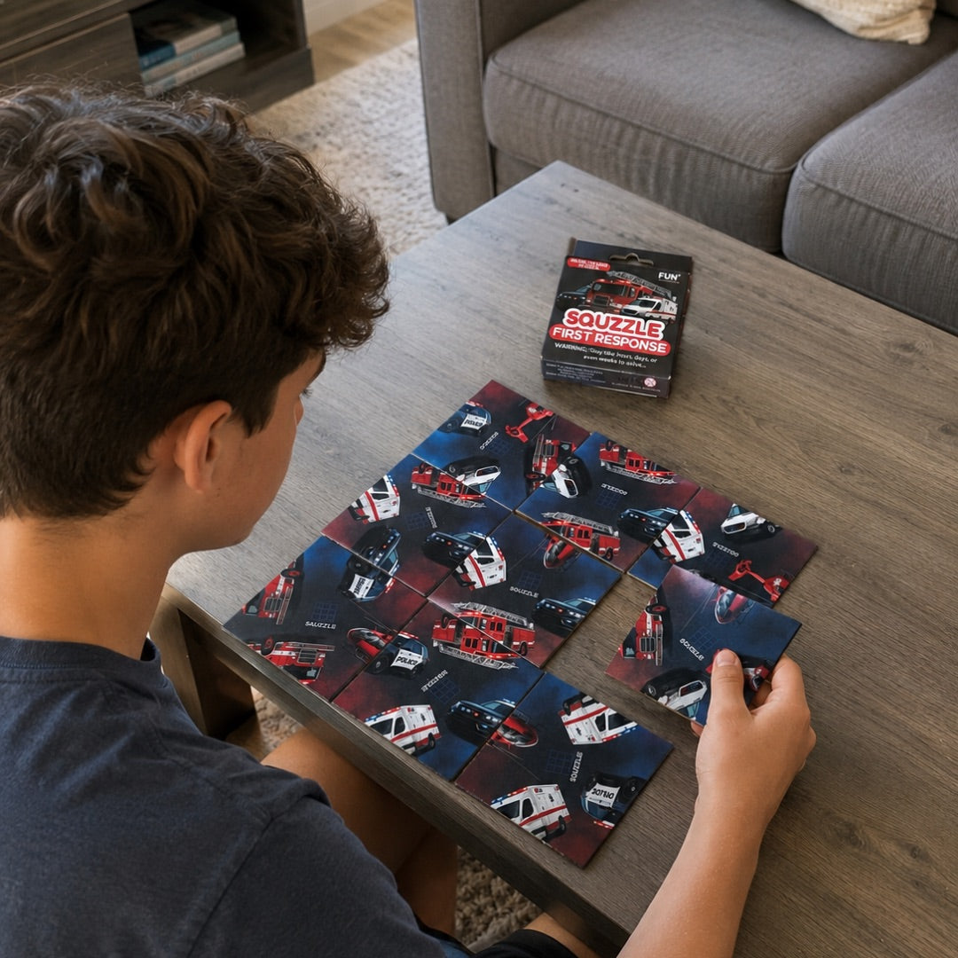A person arranging nine First Response Squzzle picture tiles at a table, with the matching box nearby.
