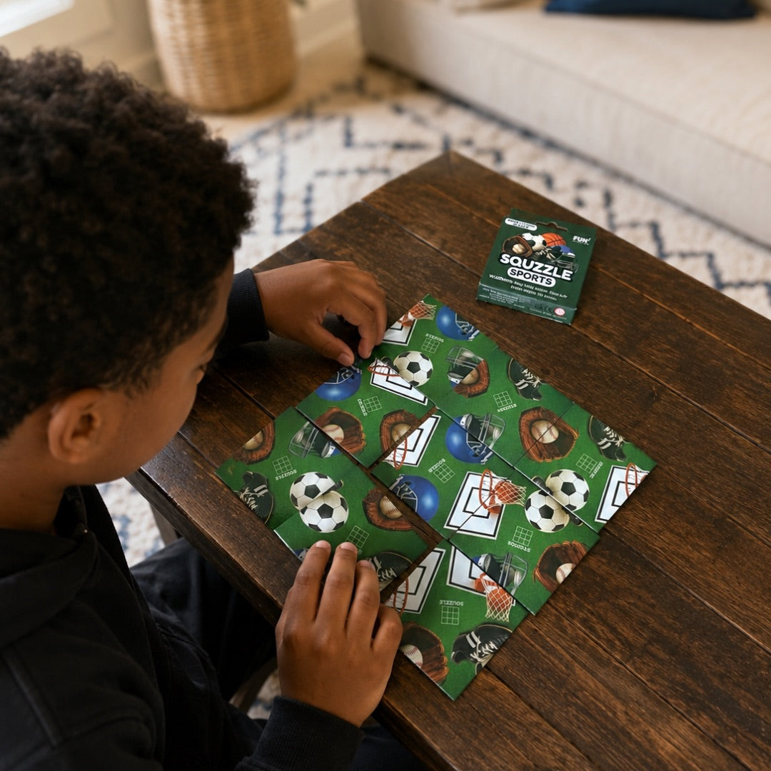 A person arranging nine Sports Squzzle picture tiles at a table, with the matching box nearby.