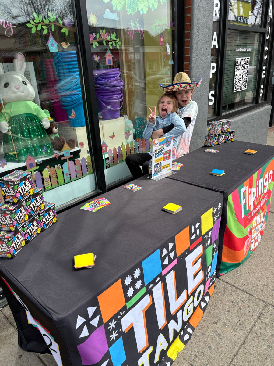 Fun Squared kids helping share games at a community event